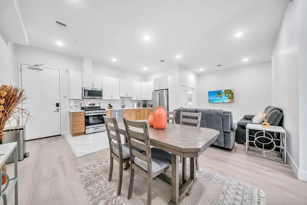 Open-plan dining table, kitchen and living area