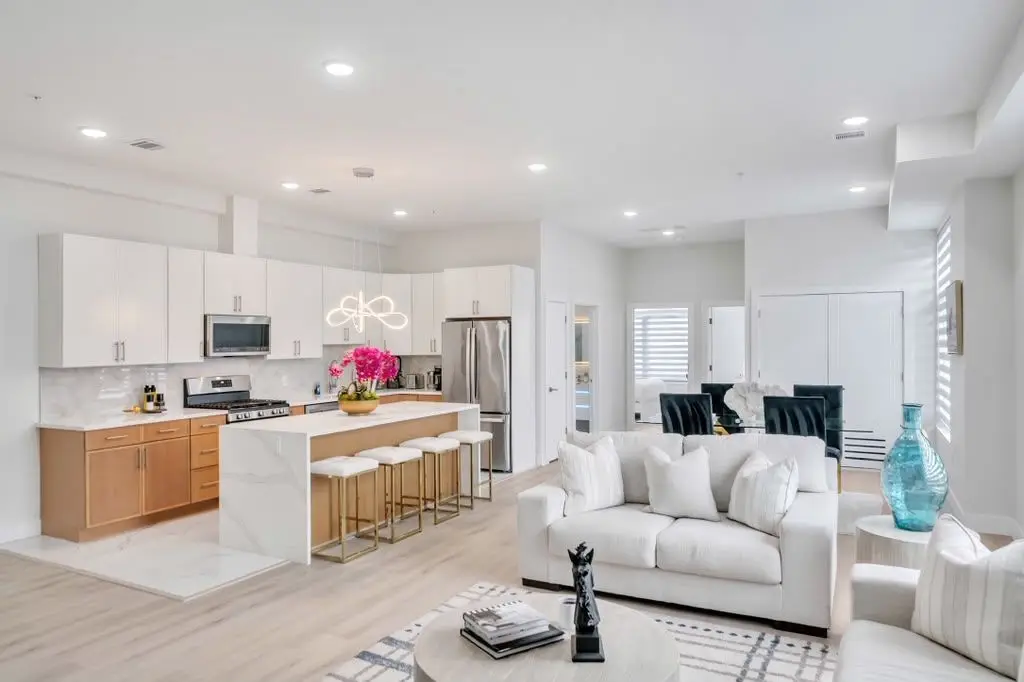 Open kitchen with island and living area beyond